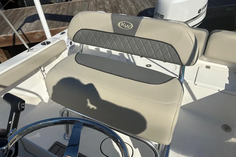 Slide: The Image of 2026 Key West 189 FS boat seat with steering wheel, featuring beige and gray upholstery. - 13