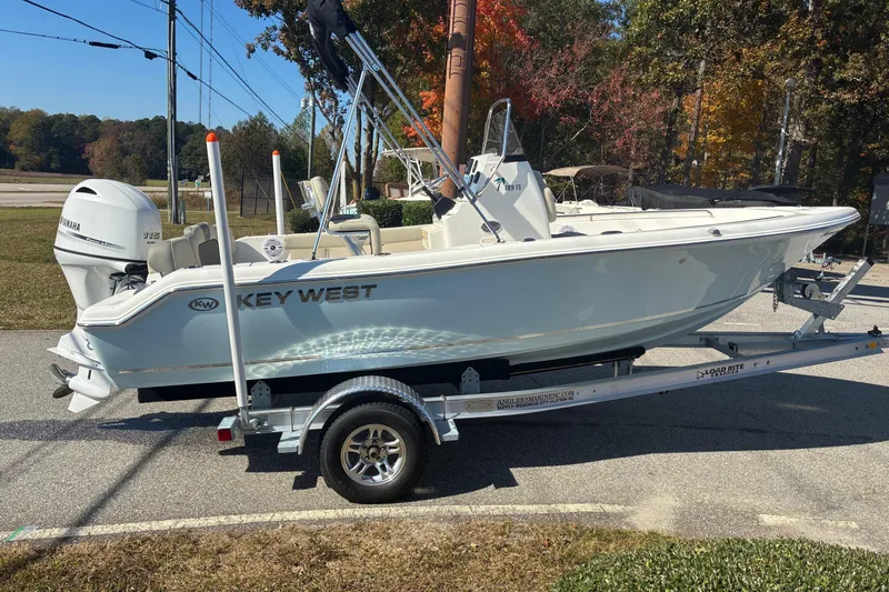 Slide: The Image of 2026 Key West 189 FS boat on trailer, parked outdoors, with Yamaha outboard motor. - 3