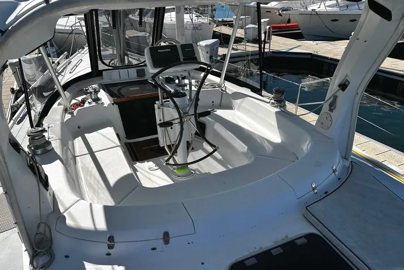 Slide: The Image of 1999 Hunter Passage 420 sailboat docked at marina under clear blue sky. - 10