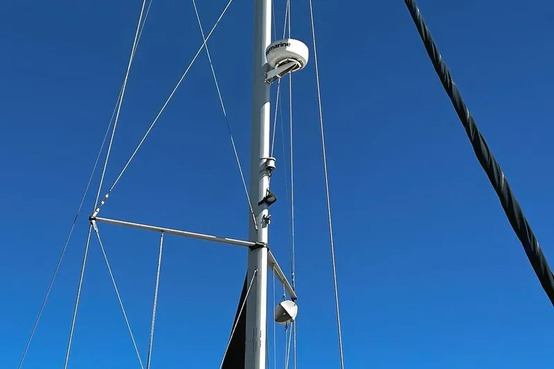 Slide: The Image of Mast of 1999 Hunter Passage 420 sailboat against clear blue sky. - 15