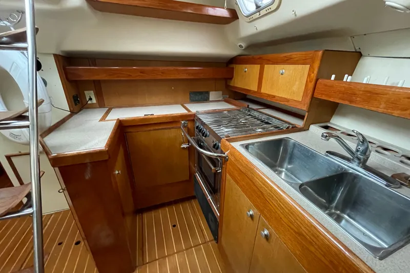 Slide: The Image of Interior of 1999 Hunter Passage 420 yacht with wooden finish and blue seating. - 18