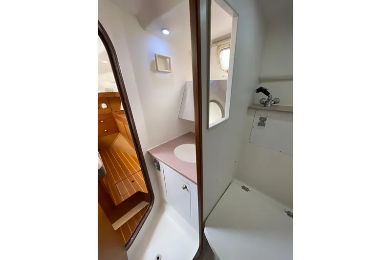 Slide: The Image of Cozy cabin interior of 1999 Hunter Passage 420 sailboat with skylight and wood finish. - 23