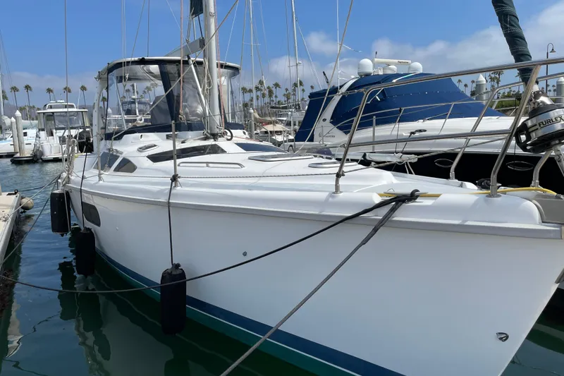 Slide: The Image of 1999 Hunter Passage 420 sailboat docked at a marina under clear blue skies. - 3