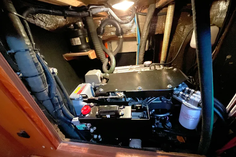 Slide: The Image of Engine room of 1999 Hunter Passage 420 sailboat with visible wiring and components. - 31