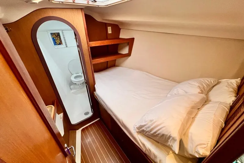 Slide: The Image of Cozy cabin interior of 1999 Hunter Passage 420 yacht with bed and compact bathroom. - 35