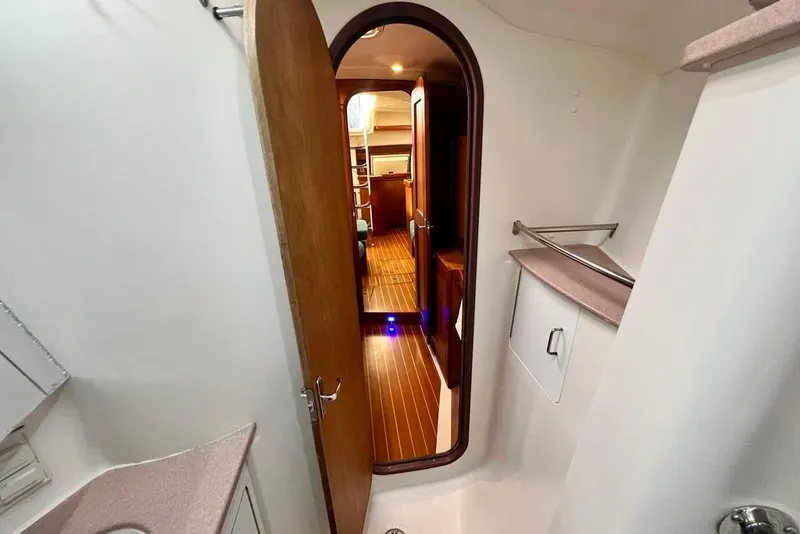 Slide: The Image of Interior view of 1999 Hunter Passage 420 sailboat, featuring wooden flooring and cabinetry. - 39