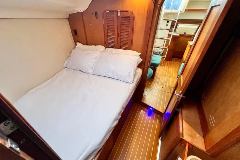 Slide: The Image of Cozy cabin interior of 1999 Hunter Passage 420 sailboat with wooden flooring and bed. - 40