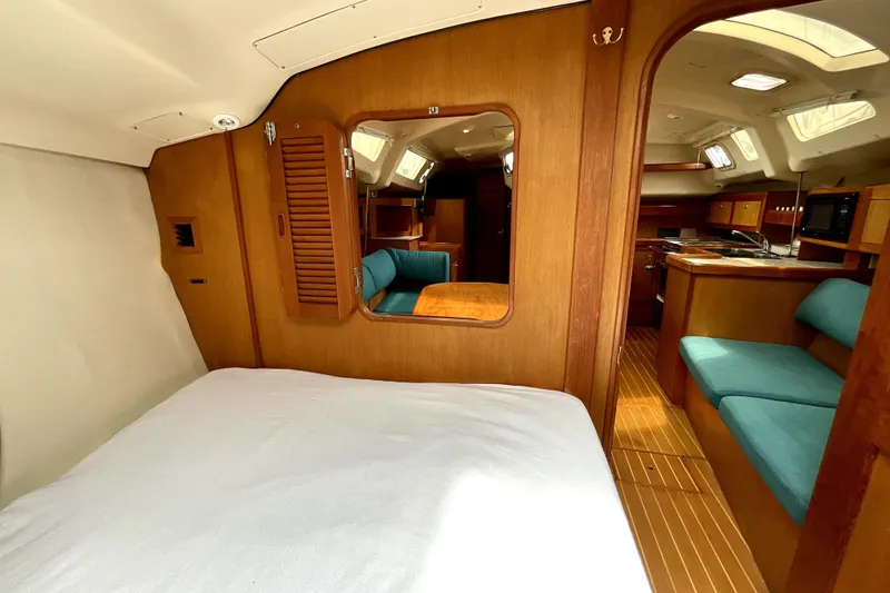 Slide: The Image of Interior of 1999 Hunter Passage 420 yacht with wood finish and teal seating. - 41