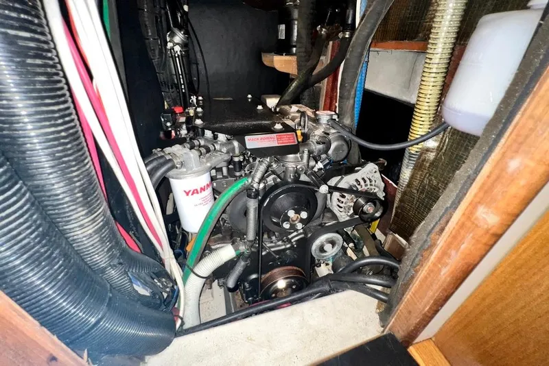 Slide: The Image of Engine compartment of a 1999 Hunter Passage 420 sailboat, featuring a Yanmar engine. - 45