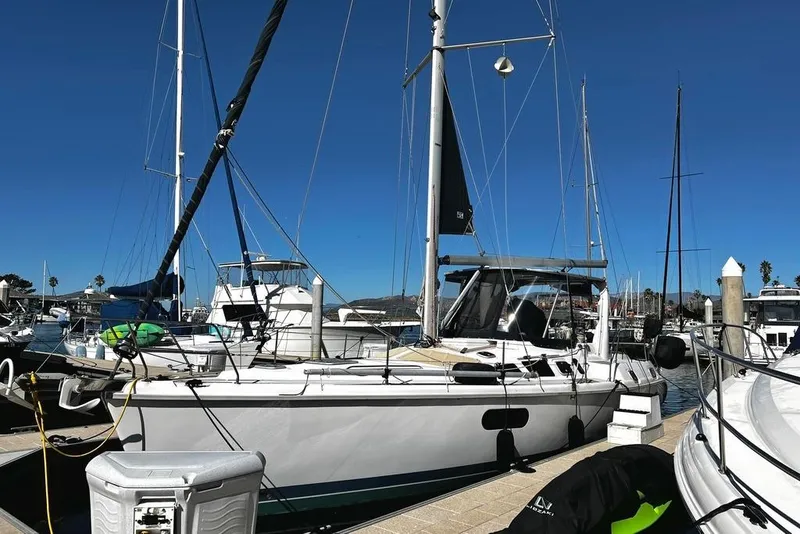 Slide: The Image of 1999 Hunter Passage 420 sailboat docked in marina, surrounded by other boats. - 5
