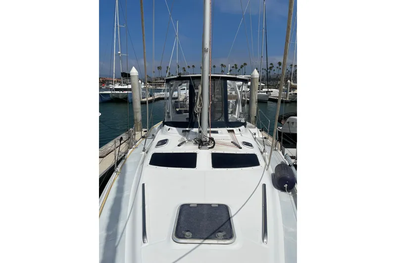 Slide: The Image of 1999 Hunter Passage 420 sailboat docked at marina with fenders and step ladder. - 8