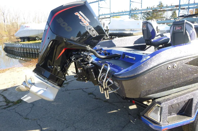 Slide: The Image of 2026 Ranger 621FS Pro boat with Mercury 300 engine, docked near water. - 11