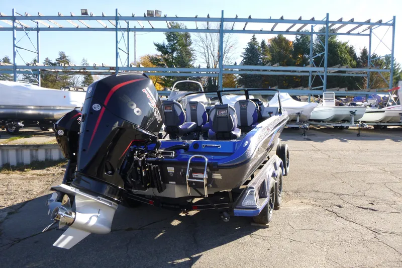 Slide: The Image of 2026 Ranger 621FS Pro boat with powerful outboard motor, parked outdoors. - 14