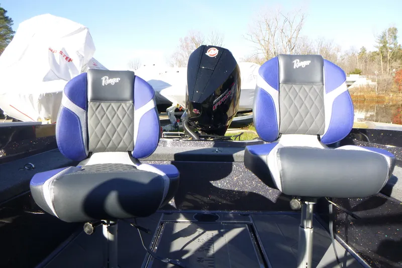 Slide: The Image of 2026 Ranger 621FS Pro boat seats with blue and black design, featuring a powerful engine. - 21