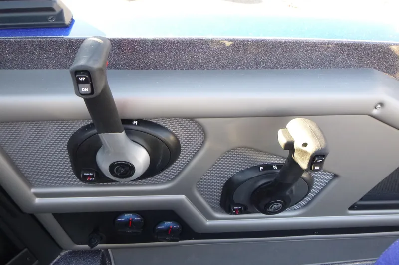 Slide: The Image of 2026 Ranger 621FS Pro boat controls with dual levers and textured panel. - 24