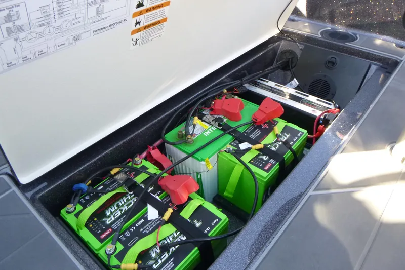 Slide: The Image of 2026 Ranger 621FS Pro boat battery compartment with multiple green batteries and wiring. - 30