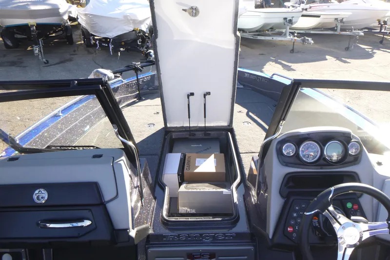 Slide: The Image of 2026 Ranger 621FS Pro boat interior with open storage compartment and dashboard view. - 32