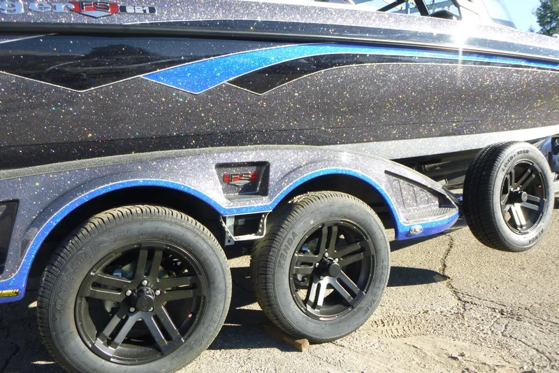 Slide: The Image of 2026 Ranger 621FS Pro boat with glittery finish and black alloy wheels. - 4