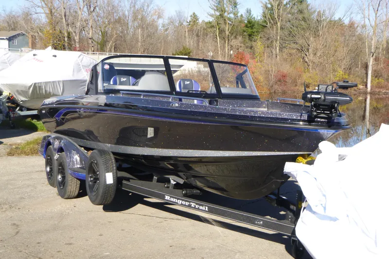 Slide: The Image of 2026 Ranger 621FS Pro boat on trailer, parked outdoors near trees. - 5