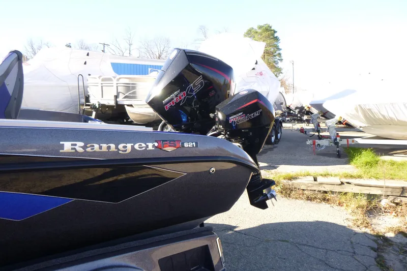 Slide: The Image of 2026 Ranger 621FS Pro boat with Mercury Pro XS engine in a marina setting. - 8