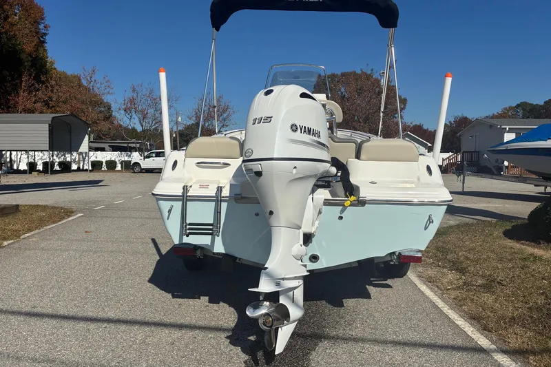 Slide: The Image of 2026 Key West 189 FS boat with Yamaha 115 engine, parked outdoors. - 2