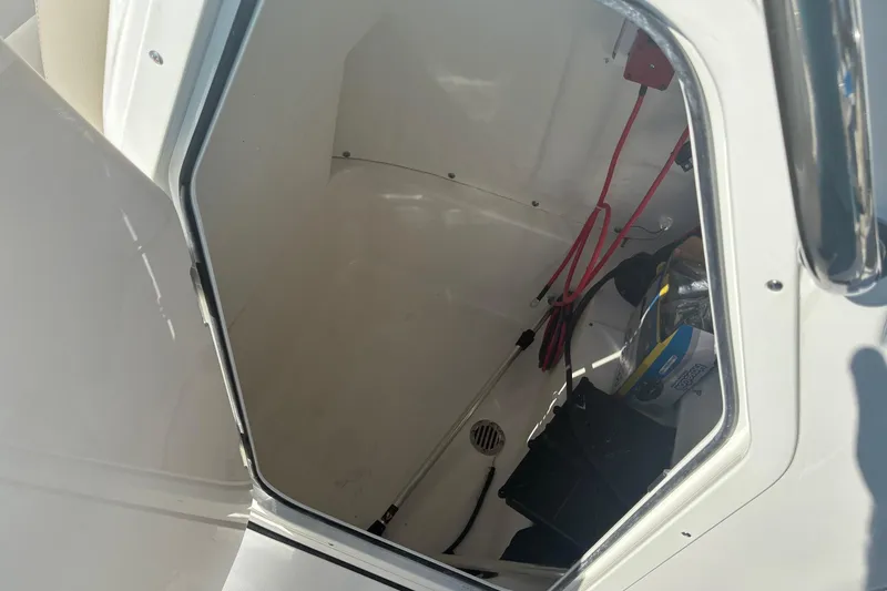 Slide: The Image of Storage compartment of 2026 Key West 189 FS boat, showing interior details and wiring. - 19