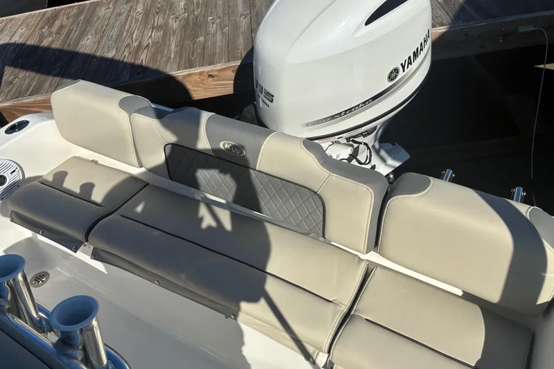 Slide: The Image of 2026 Key West 189 FS boat with Yamaha engine, featuring beige seating and wooden dock background. - 21