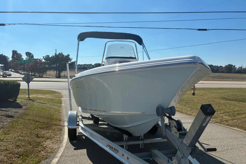 Slide: The Image of 2026 Key West 189 FS boat on trailer, parked near highway under clear blue sky. - 4