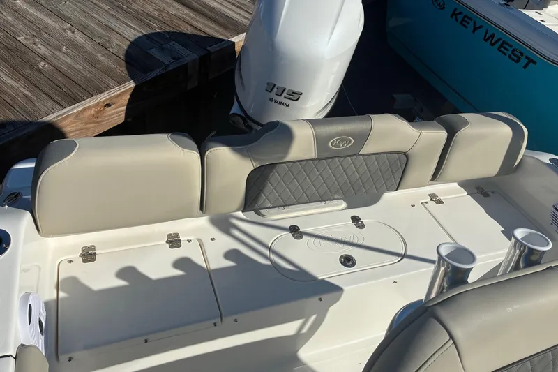 Slide: The Image of 2026 Key West 189 FS boat interior with Yamaha engine, featuring cushioned seating and rod holders. - 7