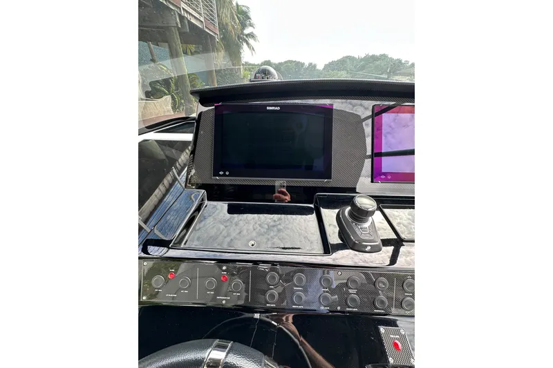 Slide: The Image of 2024 Pardo Yachts P38 dashboard with advanced navigation controls and display screens. - 15