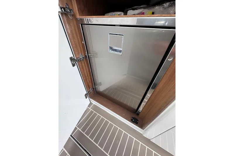Slide: The Image of Stainless steel refrigerator in 2024 Pardo Yachts P38 interior, featuring wooden cabinetry. - 30