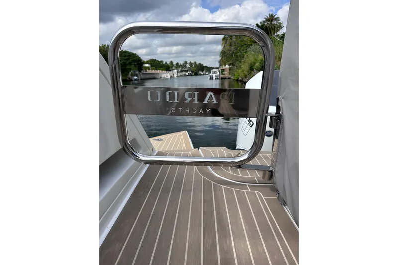 Slide: The Image of 2024 Pardo Yachts P38, rear view with logo, docked on a serene waterway. - 38