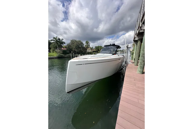 Slide: The Image of 2024 Pardo Yachts P38 docked, sleek design, under cloudy sky. - 53