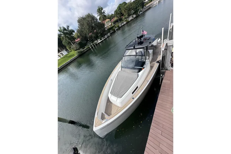 The Image of 2024 Pardo Yachts P38 docked on a serene canal with lush greenery. - 1
