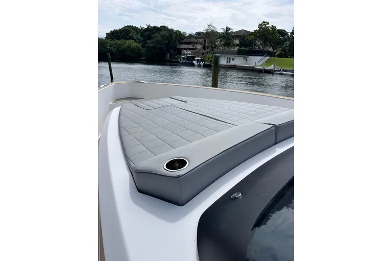 Slide: The Image of 2024 Pardo Yachts P38 with sleek deck design and luxurious seating by the water. - 11