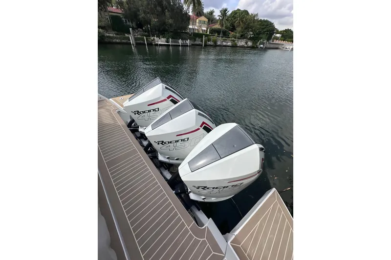 Slide: The Image of Triple outboard engines on 2024 Pardo Yachts P38, docked by a serene waterfront. - 3