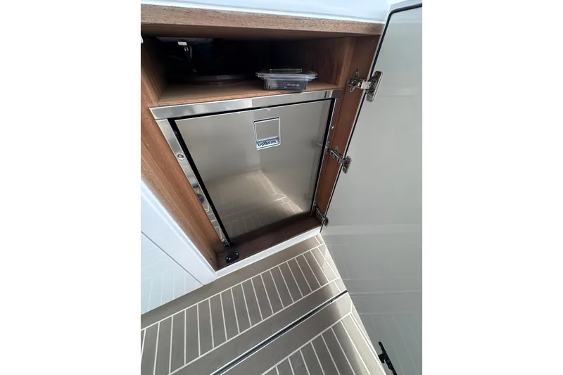 Slide: The Image of Stainless steel fridge in 2024 Pardo Yachts P38 interior, open cabinet view. - 31