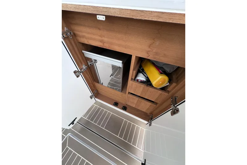 Slide: The Image of 2024 Pardo Yachts P38 interior storage with wooden cabinetry and stainless steel flooring. - 32