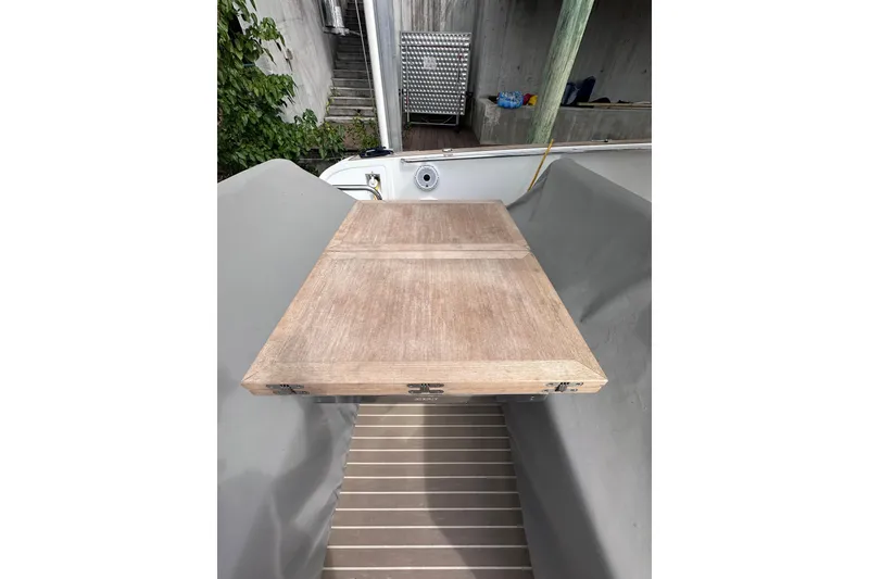 Slide: The Image of 2024 Pardo Yachts P38 wooden deck detail with surrounding dock area. - 34