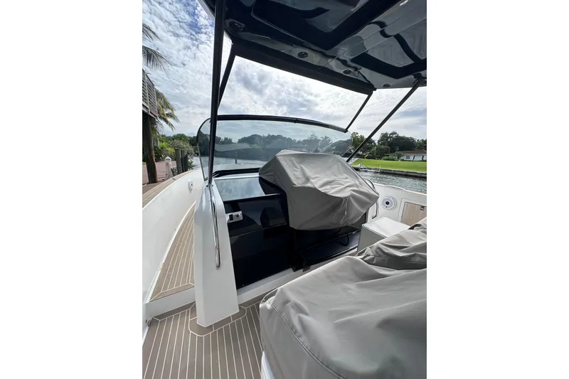 Slide: The Image of 2024 Pardo Yachts P38 cockpit with covered seats, dockside view, and sleek design. - 5