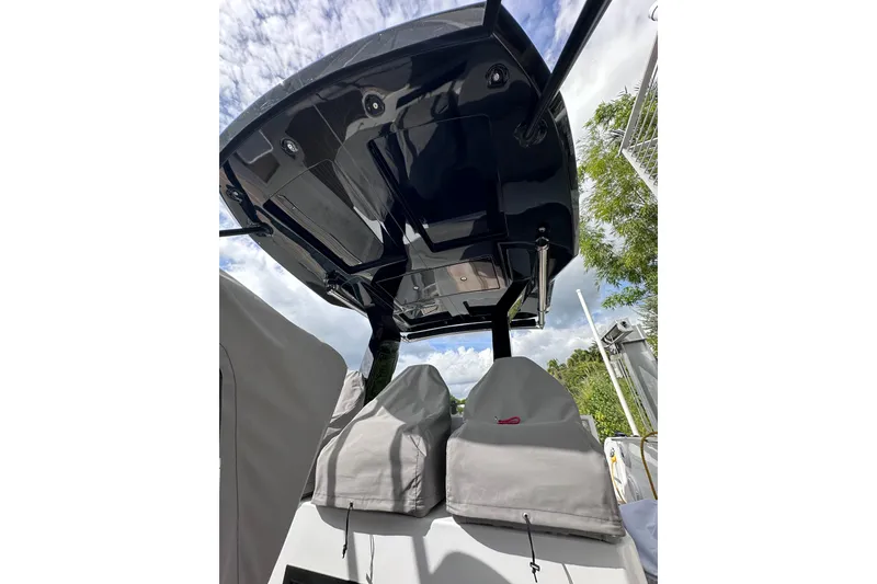 Slide: The Image of 2024 Pardo Yachts P38 boat canopy and covered seats under a cloudy sky. - 66