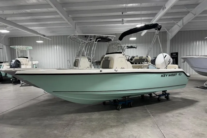The Image of 2026 Key West 189 FS boat in showroom, mint green hull, black canopy. - 1