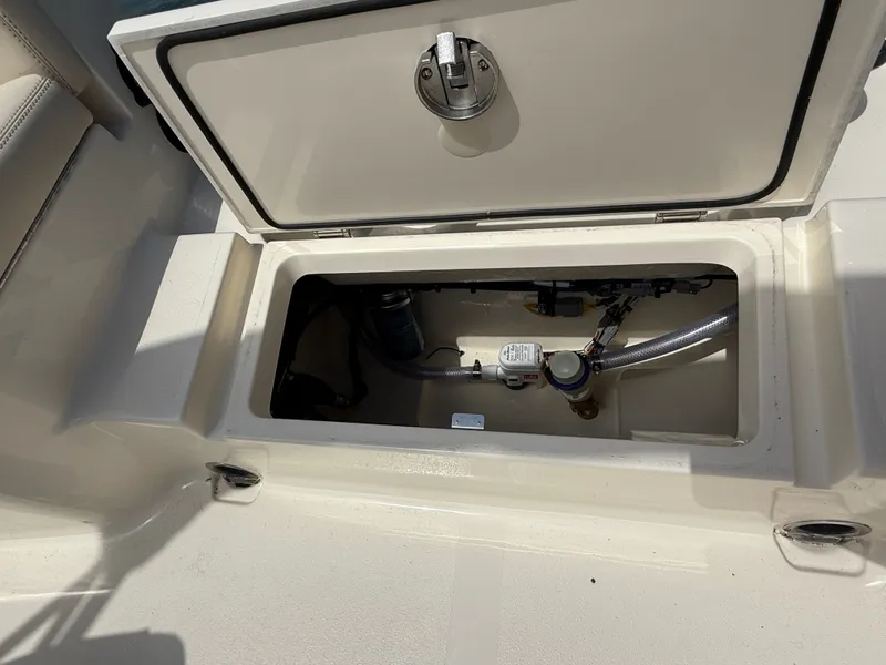 Slide: The Image of Scout 188 Sport Dorado 2026, open storage compartment with equipment. - 10