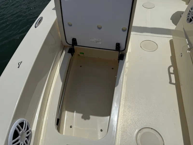 Slide: The Image of Scout 188 Sport Dorado 2026, open storage compartment on boat. - 14
