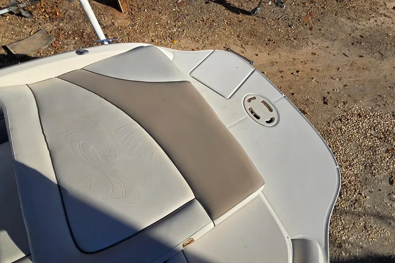 Slide: The Image of 2002 Sea Ray 220 Bow Rider boat deck with cushioned seating and swim platform. - 12