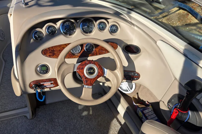 Slide: The Image of 2002 Sea Ray 220 Bow Rider dashboard with steering wheel and instrument panel. - 15