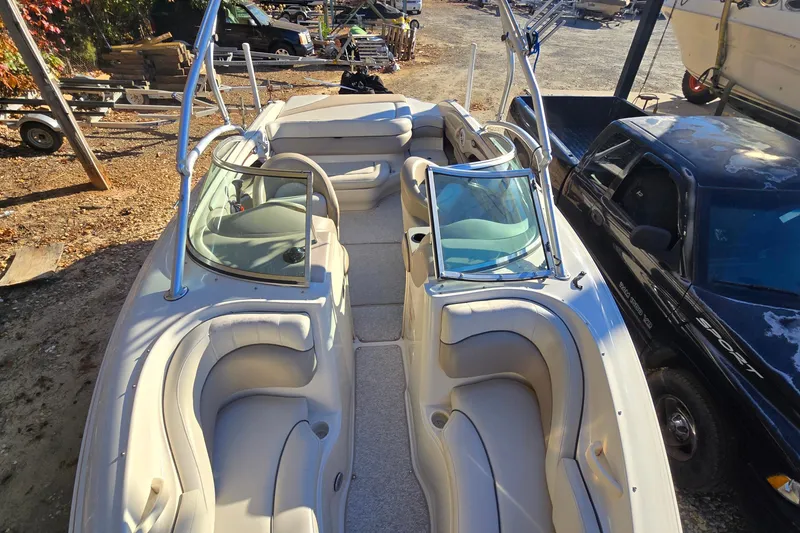 Slide: The Image of 2002 Sea Ray 220 Bow Rider boat with spacious seating and sleek design. - 17
