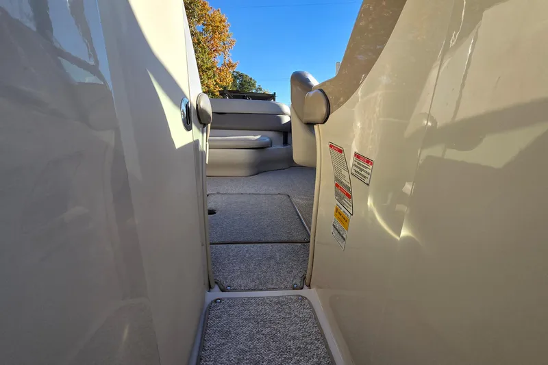 Slide: The Image of 2002 Sea Ray 220 Bow Rider interior with carpeted steps and seating area. - 21