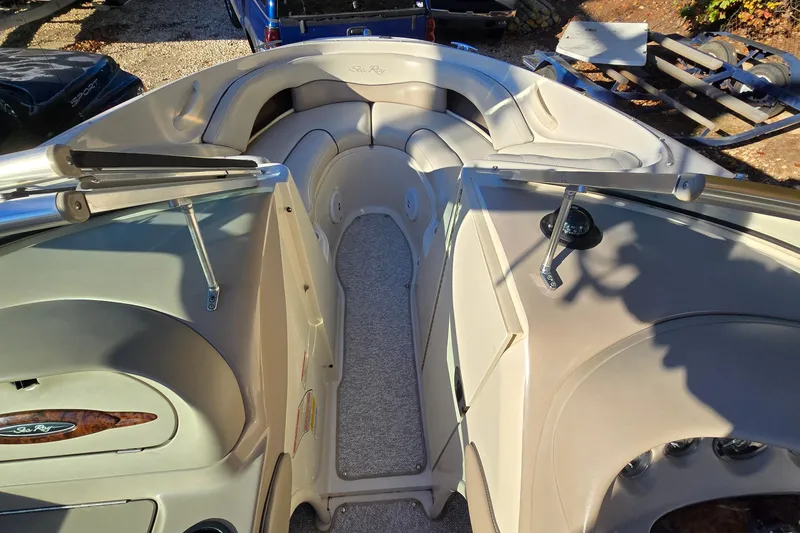 Slide: The Image of 2002 Sea Ray 220 Bow Rider interior with seating and dashboard view. - 22