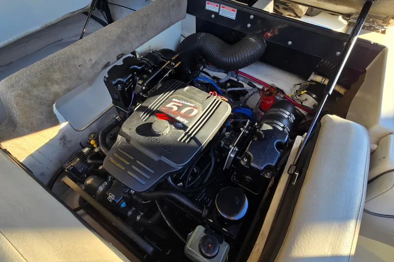 Slide: The Image of Engine compartment of a 2002 Sea Ray 220 Bow Rider boat, featuring a Mercury 5.0 MPI engine. - 24